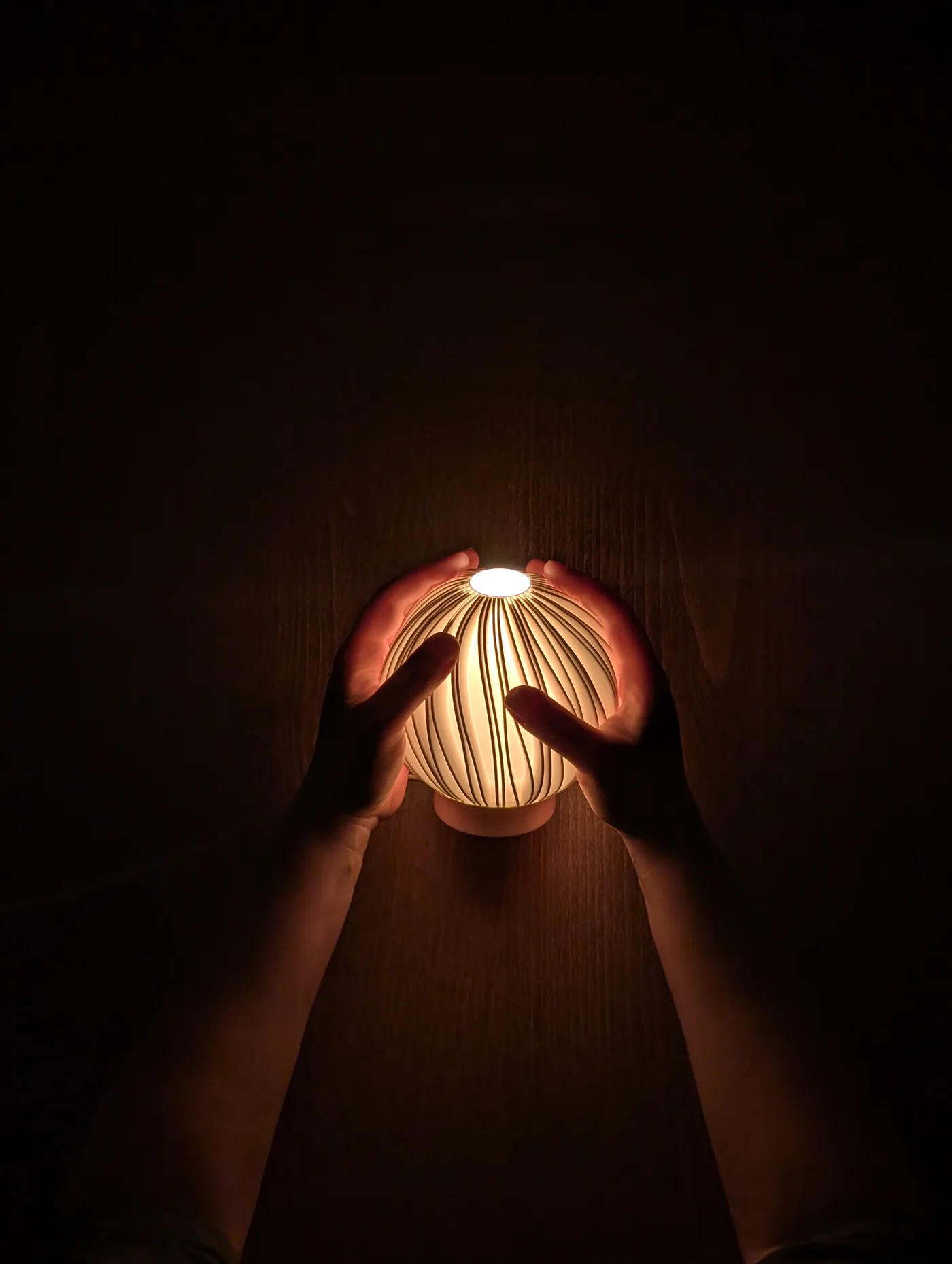 Rima Lille lamp held in one hand for scale